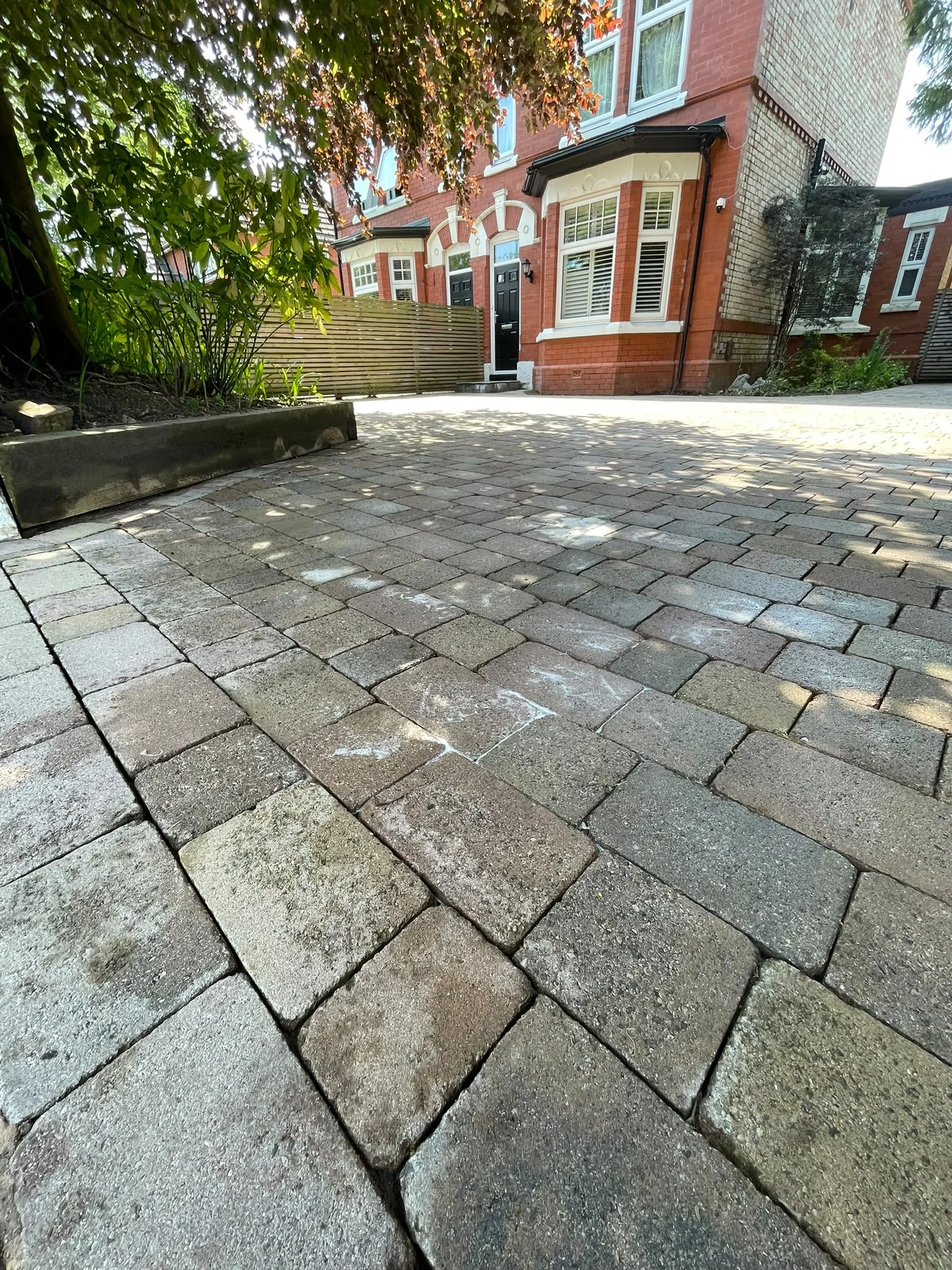 Close-up of kiln-dried sand in the joints between freshly cleaned block pavers