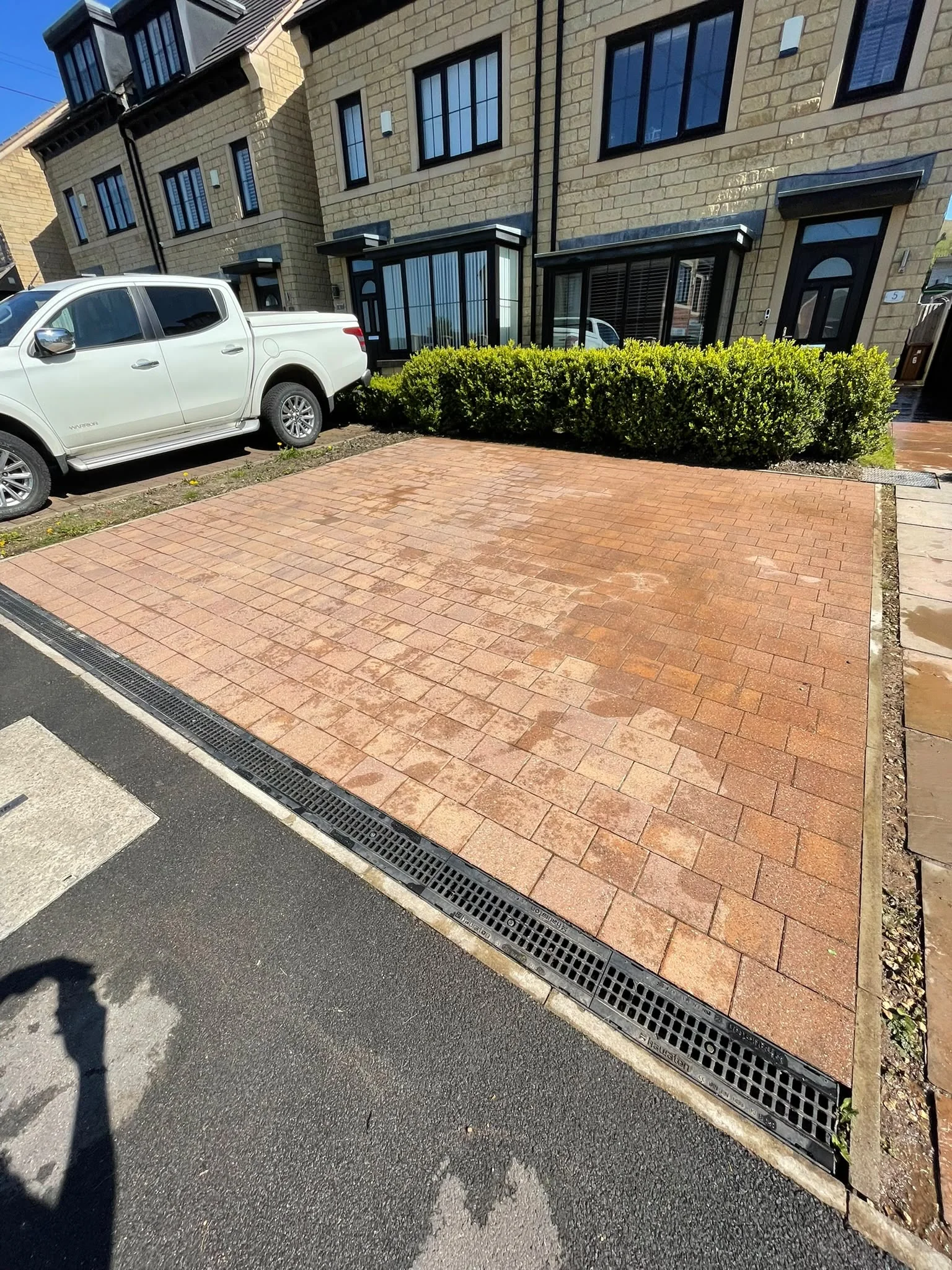 Clean driveway drying in the sun after a surface wash