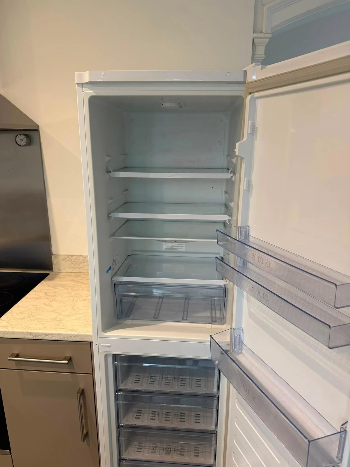 Clean glass shelves in a deep-cleaned fridge