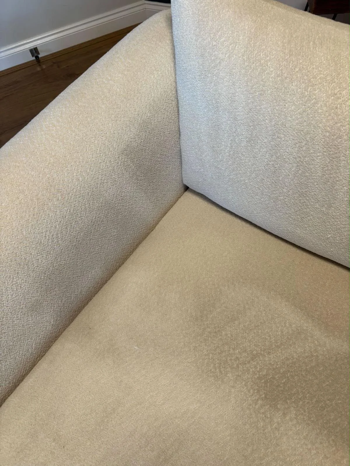 Cream sofa armrest with dirt build-up before cleaning
